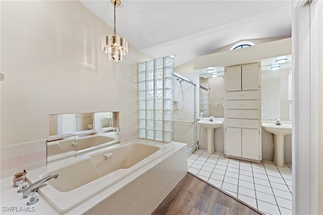 bathroom featuring lofted ceiling, hardwood / wood-style flooring, a notable chandelier, and sink