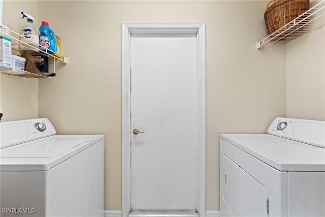 clothes washing area featuring separate washer and dryer