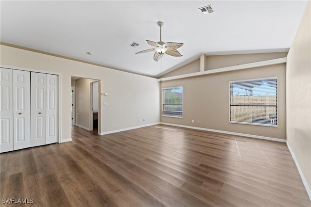 unfurnished bedroom featuring ceiling fan, wood-type flooring, and lofted ceiling