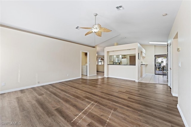 unfurnished living room featuring hardwood / wood-style flooring, ceiling fan, and vaulted ceiling