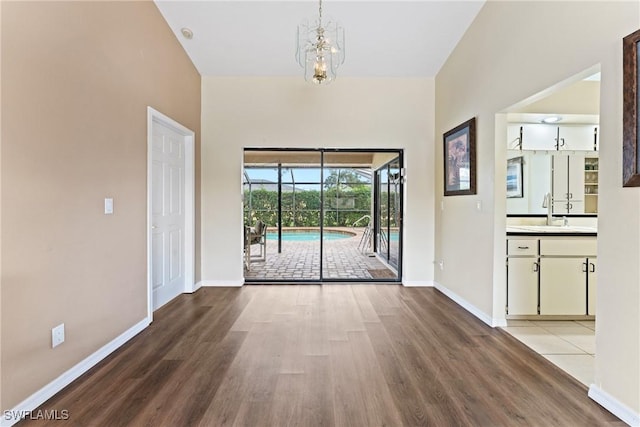 interior space with hardwood / wood-style flooring, an inviting chandelier, and sink