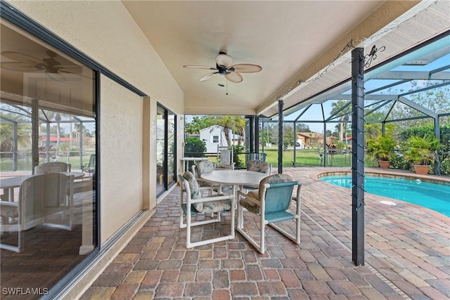 exterior space with vaulted ceiling, ceiling fan, and a swimming pool