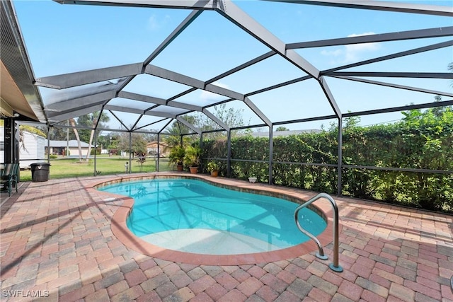 view of swimming pool featuring a lanai and a patio