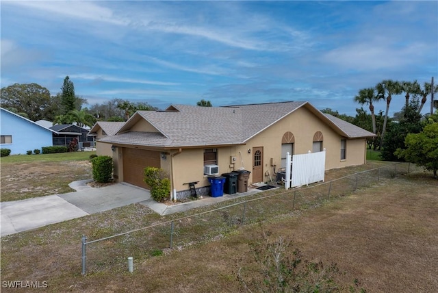 view of front of home with a garage and cooling unit