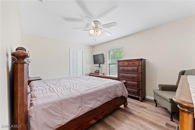 bedroom with ceiling fan, a closet, and light wood-type flooring