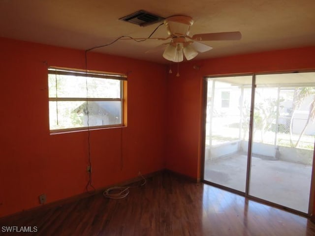 empty room with hardwood / wood-style floors and ceiling fan