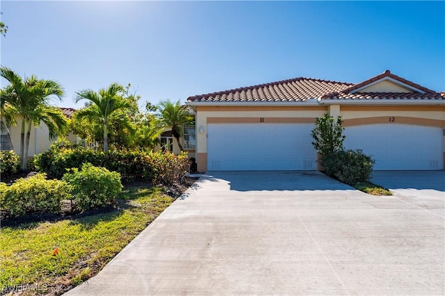 mediterranean / spanish home with a garage