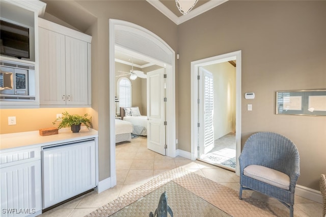 interior space featuring ornamental molding, tile patterned floors, and a healthy amount of sunlight