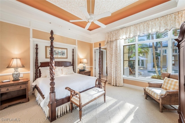 bedroom featuring a raised ceiling, ceiling fan, and crown molding