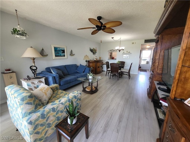 living room with a textured ceiling, ceiling fan with notable chandelier, and light hardwood / wood-style floors