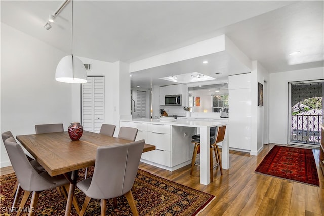 dining area with light hardwood / wood-style floors