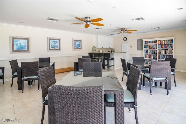 dining area featuring light tile patterned floors, ceiling fan, and crown molding