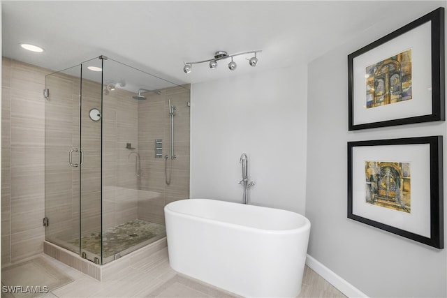 bathroom featuring tile patterned flooring and independent shower and bath