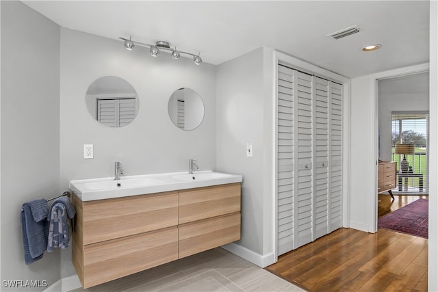 bathroom featuring vanity and hardwood / wood-style flooring