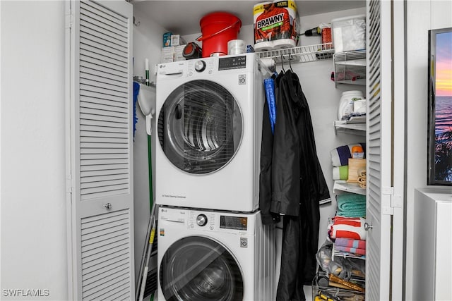 laundry room with stacked washer / drying machine