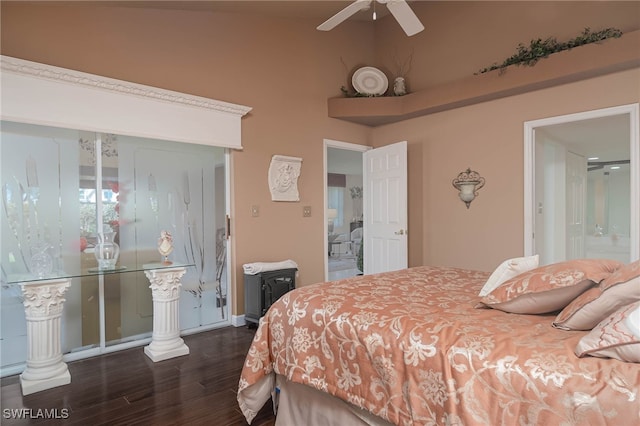 bedroom with ensuite bathroom, dark hardwood / wood-style floors, ceiling fan, and vaulted ceiling