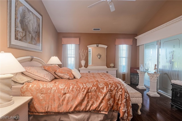 bedroom with dark hardwood / wood-style floors, multiple windows, lofted ceiling, and ceiling fan