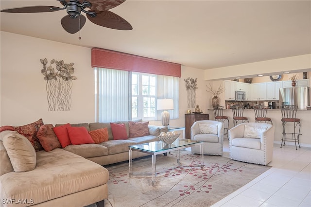 living room with ceiling fan and light tile patterned flooring