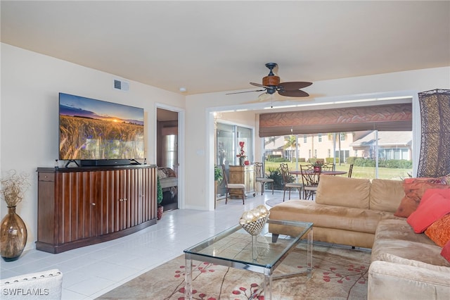 living room featuring light tile patterned floors and ceiling fan