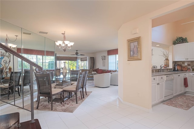 dining area featuring ceiling fan, light tile patterned floors, and lofted ceiling