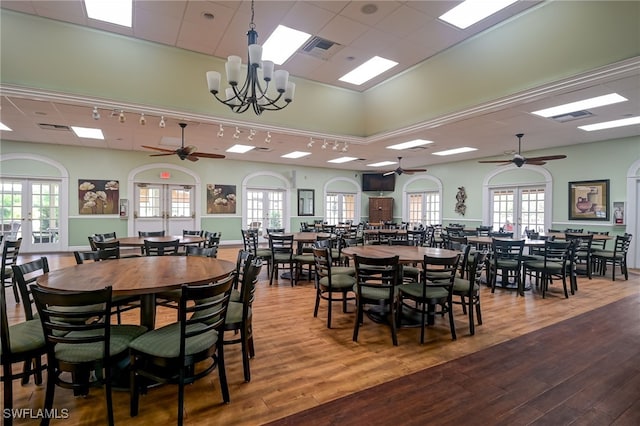 dining space with french doors, plenty of natural light, and wood-type flooring