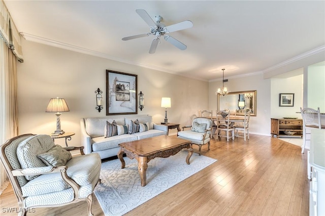 living room featuring ceiling fan with notable chandelier, light hardwood / wood-style floors, and crown molding