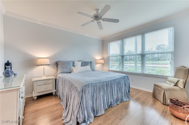 bedroom with light hardwood / wood-style floors, ceiling fan, and crown molding