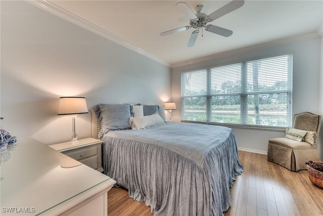 bedroom with multiple windows, light wood-type flooring, ceiling fan, and ornamental molding