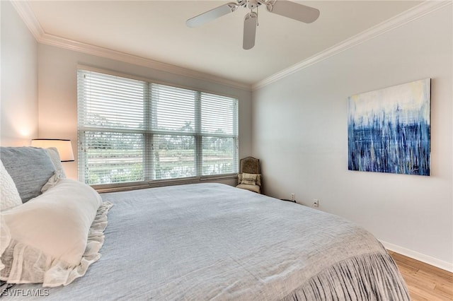 bedroom with ceiling fan, light wood-type flooring, and ornamental molding