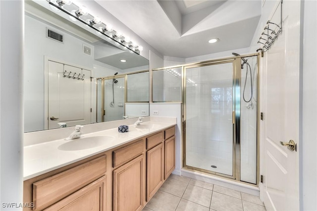 bathroom with tile patterned flooring, vanity, and an enclosed shower