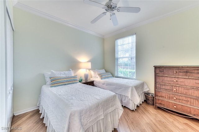 bedroom with light hardwood / wood-style floors, ceiling fan, and ornamental molding