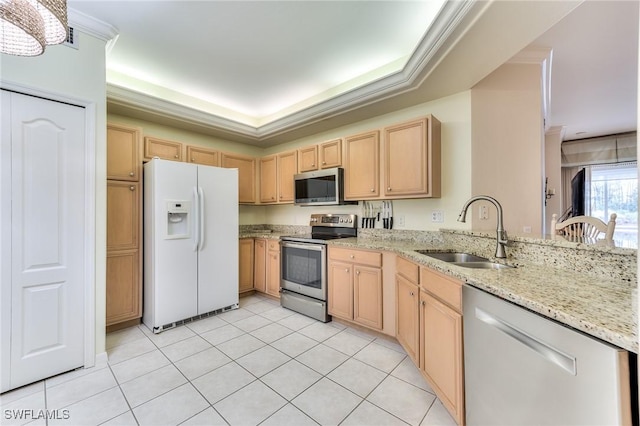 kitchen featuring light tile patterned floors, sink, appliances with stainless steel finishes, and a tray ceiling