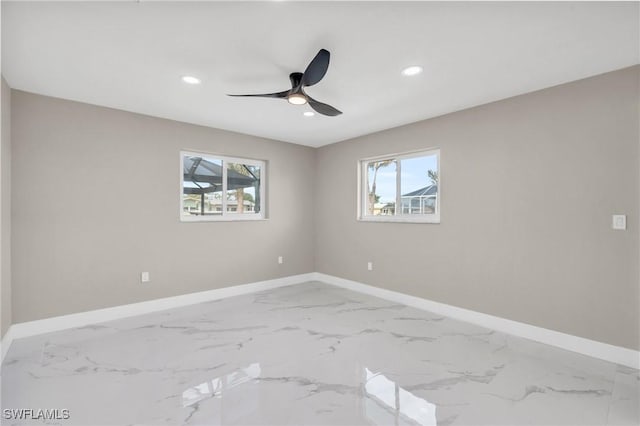 unfurnished room with ceiling fan and plenty of natural light