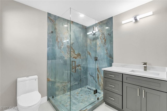 bathroom with an enclosed shower, vanity, and toilet