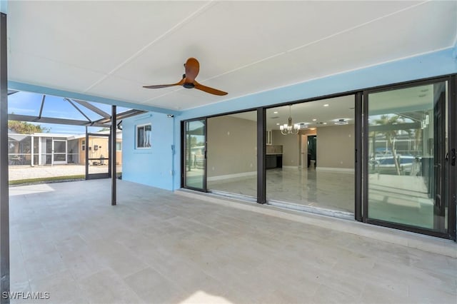 view of patio featuring ceiling fan and a lanai