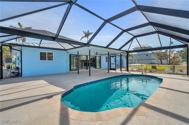 view of pool with a patio, ceiling fan, and a lanai