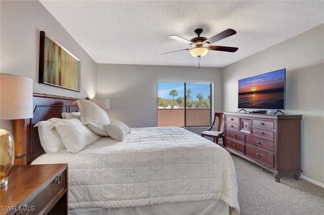 bedroom with a textured ceiling, baseboards, a ceiling fan, and light colored carpet