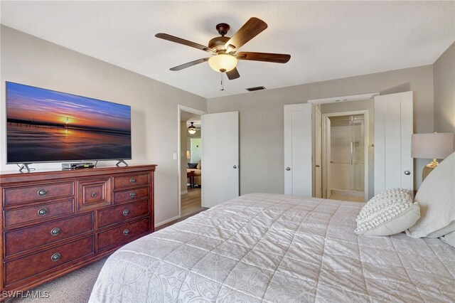 bedroom with ensuite bath, visible vents, ceiling fan, and light colored carpet