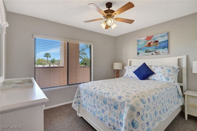 carpeted bedroom featuring baseboards and a ceiling fan