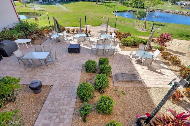 view of patio / terrace featuring area for grilling and a water view