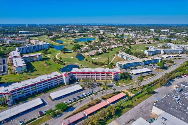 birds eye view of property featuring a view of city and a water view