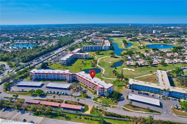 birds eye view of property with a water view and a city view