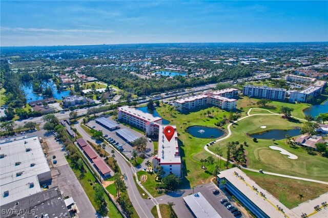 bird's eye view featuring golf course view and a water view