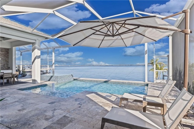 view of swimming pool with a patio and a water view