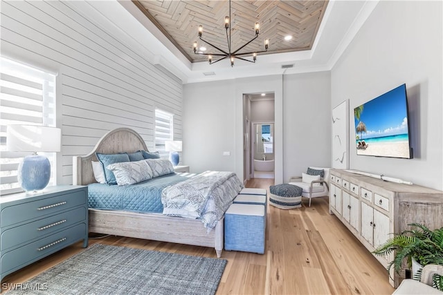 bedroom with connected bathroom, wooden ceiling, ornamental molding, a raised ceiling, and a notable chandelier