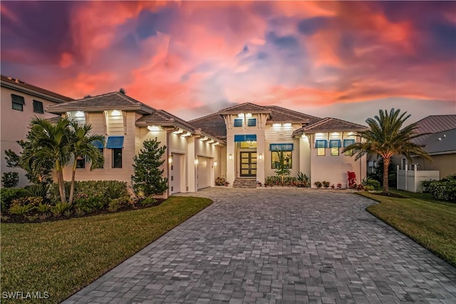 mediterranean / spanish house featuring a yard