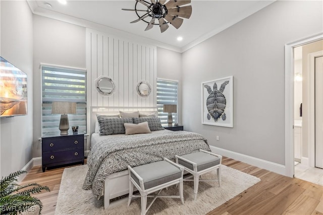 bedroom with hardwood / wood-style flooring, ceiling fan, ensuite bathroom, and crown molding