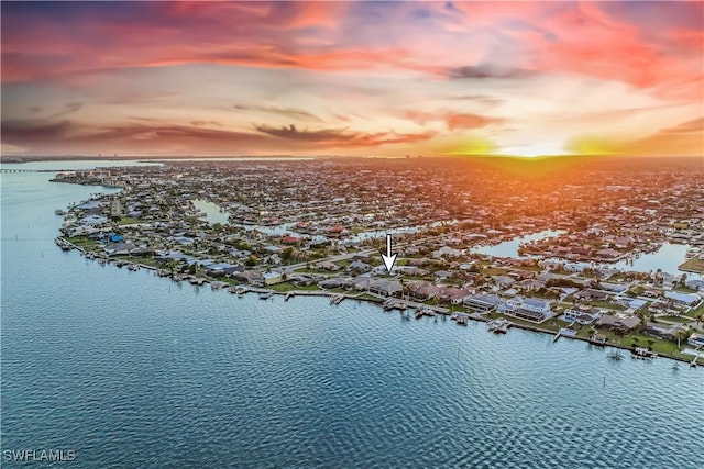 aerial view at dusk with a water view