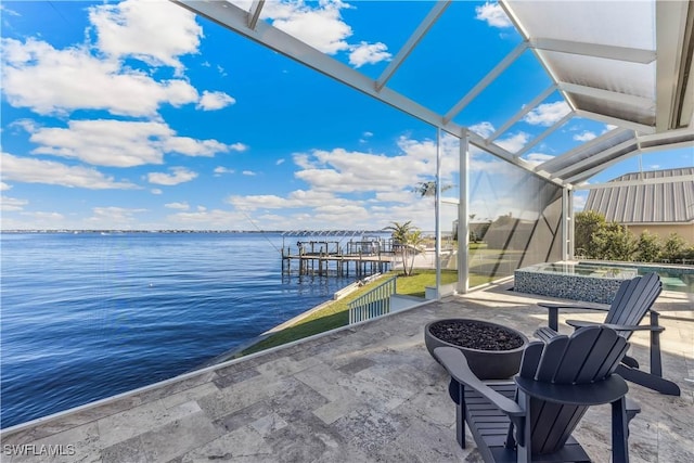 view of patio / terrace with a jacuzzi and a water view