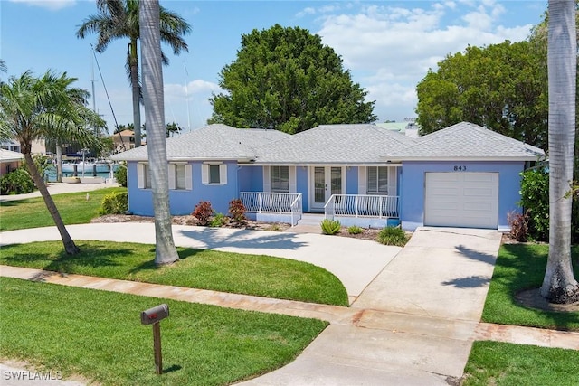 ranch-style home with a front lawn, a porch, and a garage